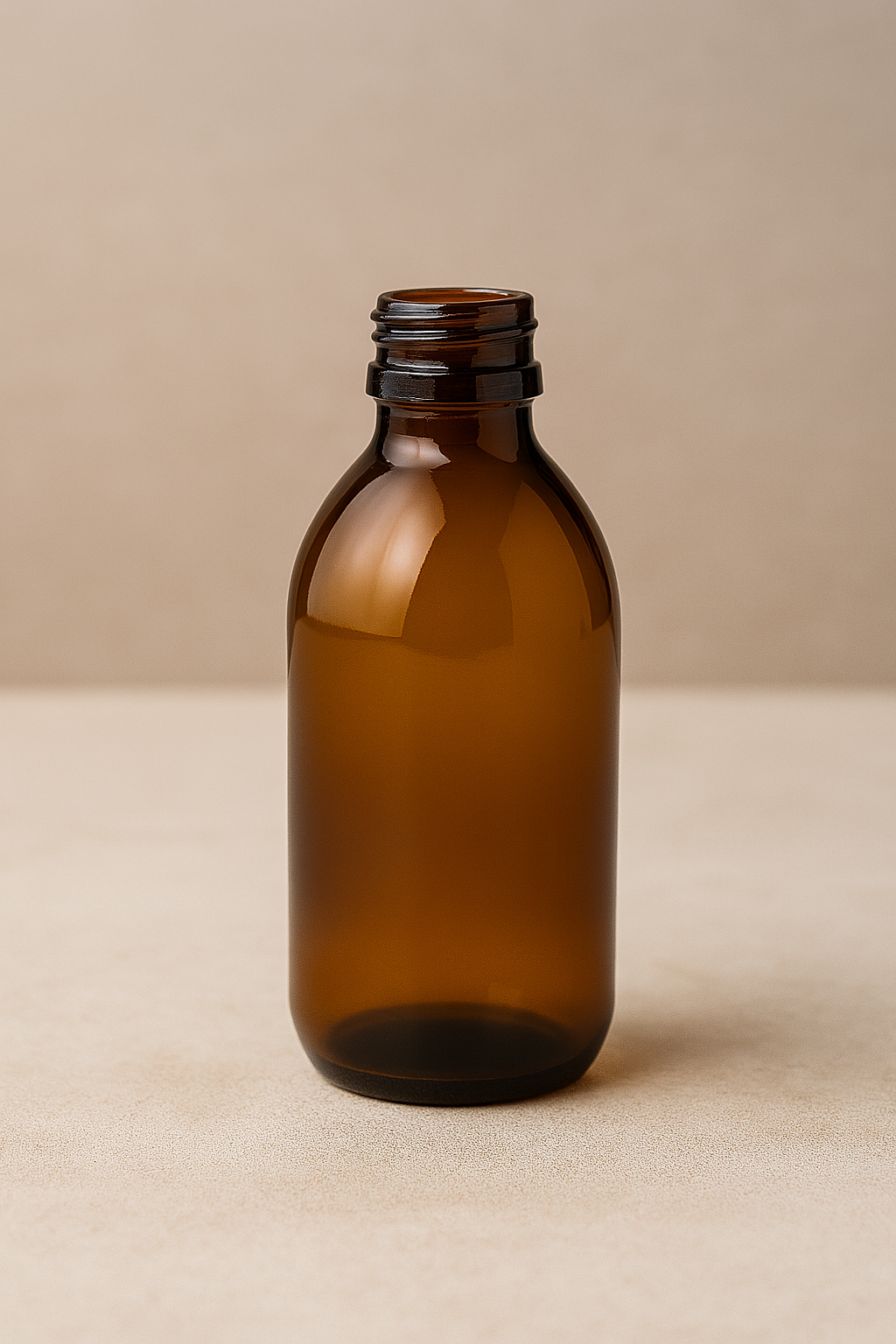 Close-up of 200ml amber round pharma bottle without black wadded cap, perfect for medicinal and skincare packaging in New Zealand.