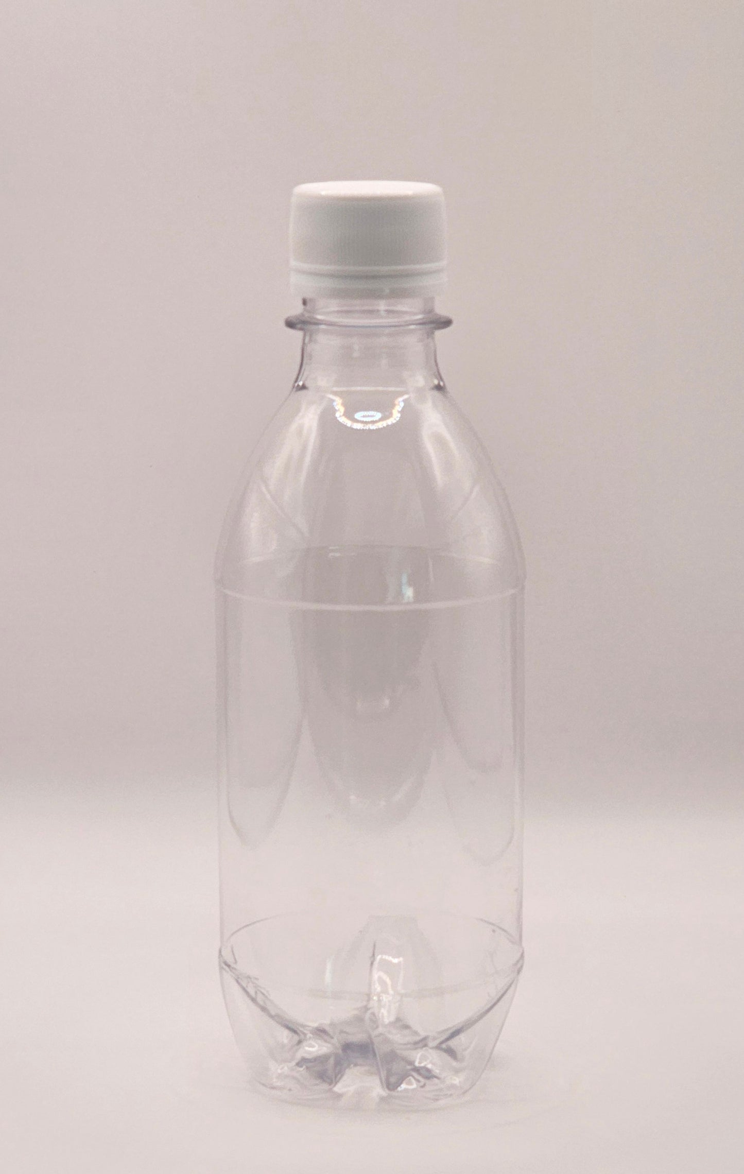 350ml clear CO2 carbo bottle with 28mm cap filled with pink lemonade on outdoor table – Croftpak NZ packaging
