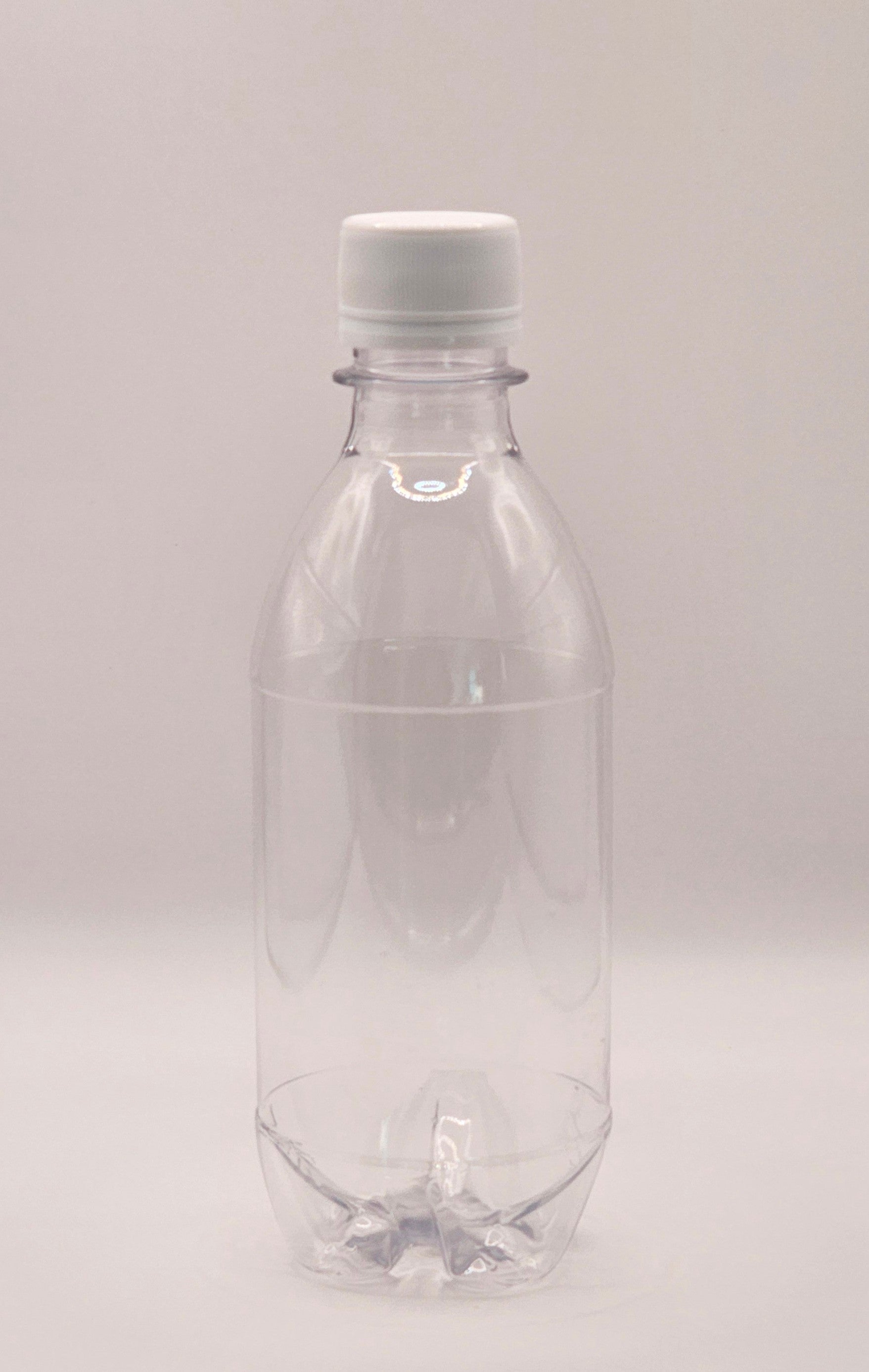 350ml clear CO2 carbo bottle with 28mm cap filled with pink lemonade on outdoor table – Croftpak NZ packaging